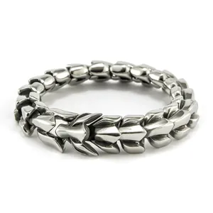 Macro shot of silver stainless steel dragon bone link bracelet with detailed metal texture
