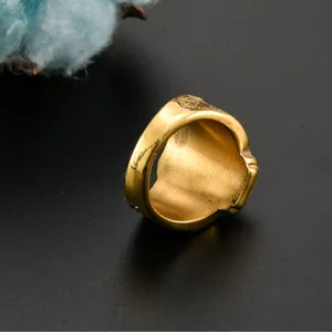 Detailed top view of gold-plated tiger head signet ring with embossed side texture