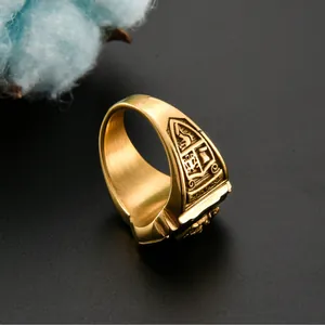 Macro detail of gold stainless steel signet ring with engraved heraldic shield emblem