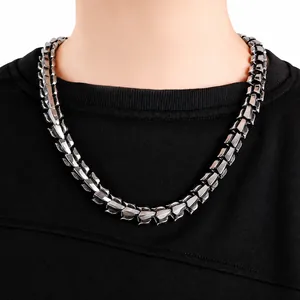 Close-up of men's chunky stainless steel dragon bone chain necklace on neck