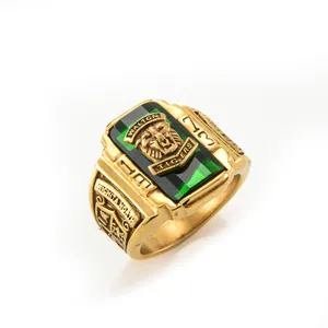 Macro detail of gold-plated tiger signet ring with green gemstone and 1973 engraving