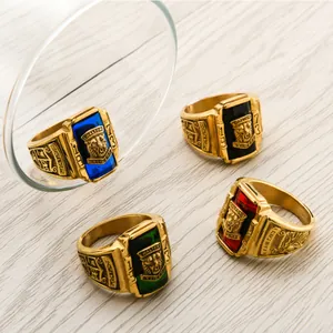 Golden Walton Tigers rings with colorful gemstones and tiger relief on wood surface