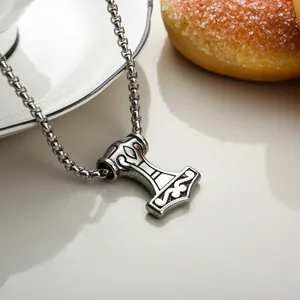 Detailed close-up of retro Mjolnir pendant on a box chain with vintage engraved patterns