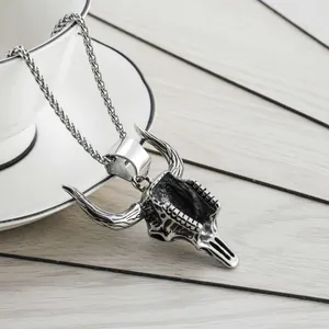Detailed macro shot of a vintage bull skull pendant on a stainless steel chain