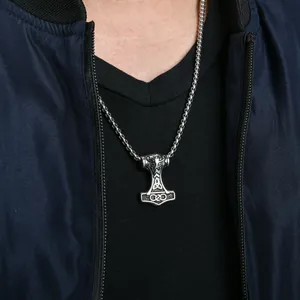 Close-up of Thor's hammer Mjolnir pendant with Celtic knots on stainless steel chain