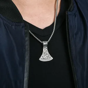 Detail of Viking axe pendant on a man's neck with intricate Nordic engravings