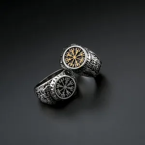 Macro detail of Viking compass rings with vintage runes and engraved steel texture