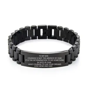 Macro detail of black stainless steel bracelet with engraved inspirational message for son