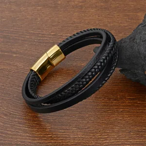 Detail of multi-layer black leather woven bracelet with a gold magnetic metal clasp