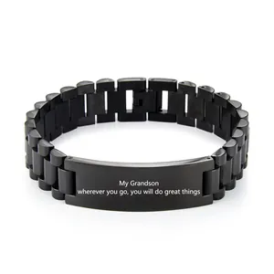 Macro detail of black stainless steel watch band bracelet with engraved message for grandson