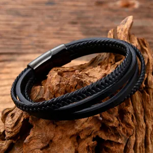 Detail of multi-layer black braided leather bracelet with black magnetic steel clasp