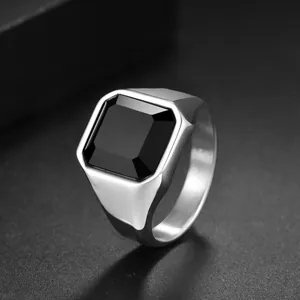Macro view of men's stainless steel ring with a large square black gemstone inlay