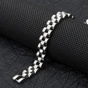 Macro shot of silver stainless steel watch-style bracelet links on a black mesh stand