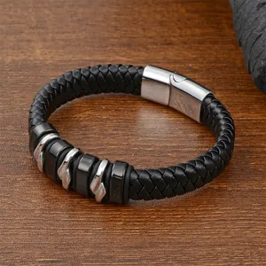 Men's black braided leather bracelet with stainless steel magnetic clasp on wood