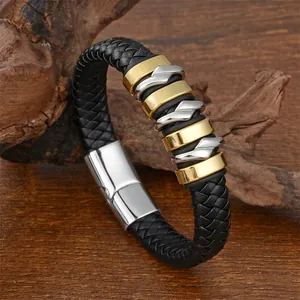 Detail of woven black leather bracelet with gold and silver twisted metal accents