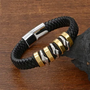 Macro detail of men's braided leather bracelet with gold and silver polished metal rings
