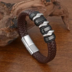Detail of multi-layer braided brown leather bracelet with silver and black metal rings