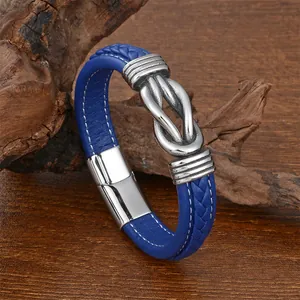 Close-up of blue braided leather bracelet featuring a silver metal infinity knot and magnetic clasp
