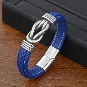 Macro detail of men's blue braided leather bracelet with silver twisted metal accent