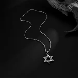Macro shot of stainless steel hexagram necklace with retro floral engravings and ball chain