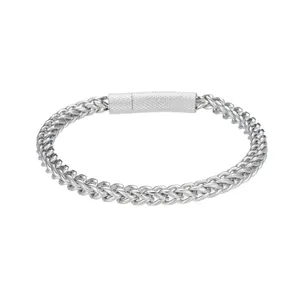 Macro detail of silver wheat link chain bracelet with knurled non-slip cylindrical clasp