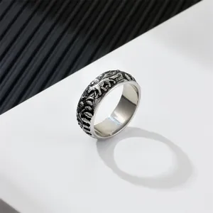 Viking style stainless steel ring featuring embossed forest wolf pack and mountain scene