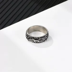 Vintage stainless steel Viking ring with embossed forest wolf and mountain pattern