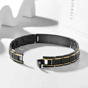 Detail of matte black and gold link bracelet with engravable blank ID tag plate