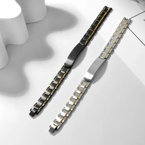 Titanium steel ID bracelets in black-gold and silver-gold finishes on a modern wave prop
