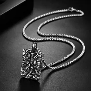 Vintage stainless steel rectangular pendant necklace with intricate Celtic relief on black background