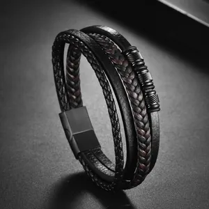 Detail of layered braided leather bracelets for men with matte black magnetic clasp