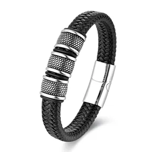 Detail showing black braided leather band with textured steel beads and magnetic clasp