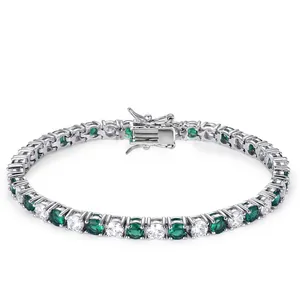 Detail of silver tennis bracelet with alternating green emerald and clear cubic zirconia