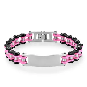 Macro detail of punk bicycle chain bracelet with pink links and stainless steel engravable plate