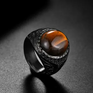 Vintage men's stainless steel ring featuring a round tiger eye stone and engraved patterns