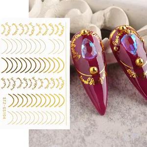 Detail of rose gold nail stickers with artistic phrases and metallic curved lines