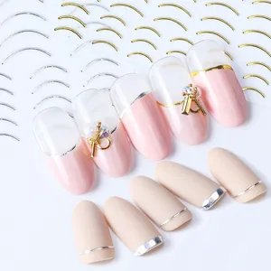 Macro shot of 3D nail art stickers with rose gold metallic lines and pearl decorations