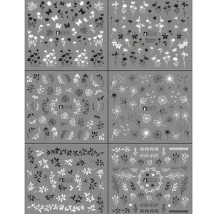 Detail of 6 floral nail stickers featuring black leaf, daisy and butterfly water decals