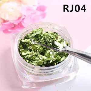 Gros plan de paillettes à ongles hexagonales vert sirène RJ04 avec petite cuillère