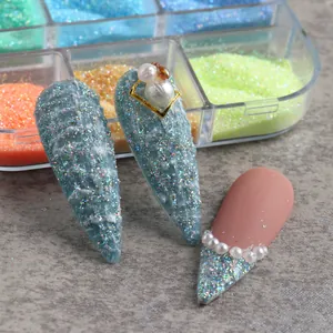 Detailed view of 3D nail art designs with blue glitter and sugar powder texture