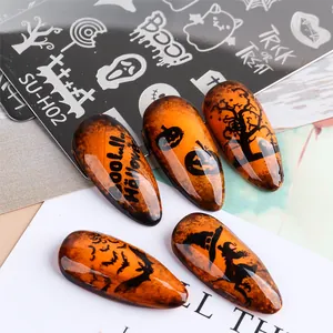 Macro shot of Halloween nail stamping kit with pumpkin and ghost pattern on amber nails