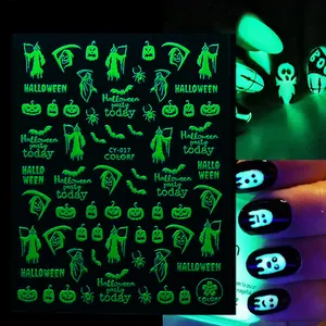 Glow-in-the-dark Halloween nail decals with pumpkin and skull patterns on black background