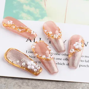 Press on nails with pink cat eye effect, 3D white flowers, pearls and gold foil edges