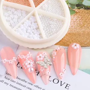 Detail of 3D white flower nail art gems and rose gold beads in a 6-grid rotating storage box