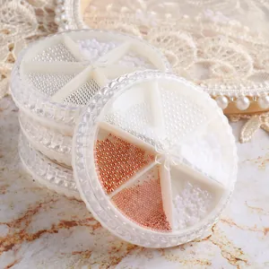 Detail view of 6-grid nail art bead wheel with white pearls and rose gold micro-beads