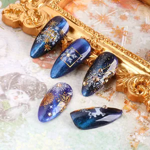 3D Christmas snowflake nail stickers with blue galaxy cat eye effect and gold deer decals