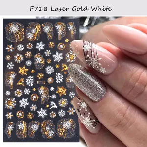 Detail of Christmas nail stickers with laser gold snowflakes and reindeer on nails