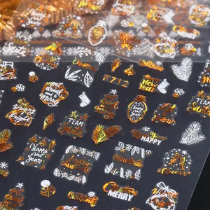 Macro detail of F712 Christmas nail art stickers with gold foil snowflakes and Santa icons