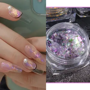 Macro detail of iridescent opal nail flakes in container and applied on long pearl nails