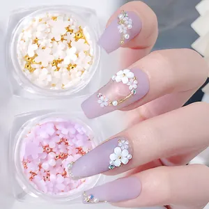 Macro detail of 3D resin flowers and metal microbeads for nail art on purple nails